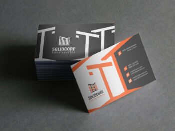 Realistic business card mockup for construction branding showcasing the "Solidcore Construction" logo with front and back designs on a dark background.